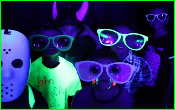 Guests glowing under UV blacklight photo booth