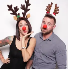 Family posing with holiday themed props and decorations