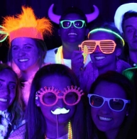 Guests glowing under UV blacklight photo booth