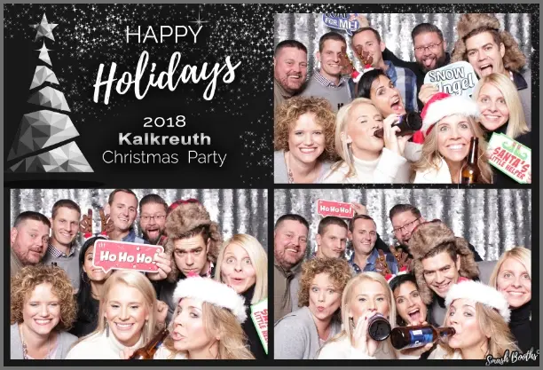 Guests with holiday props at Christmas photo booth