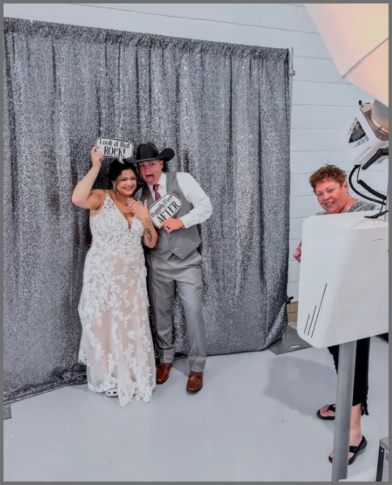Bride and groom posing together at wedding photo booth